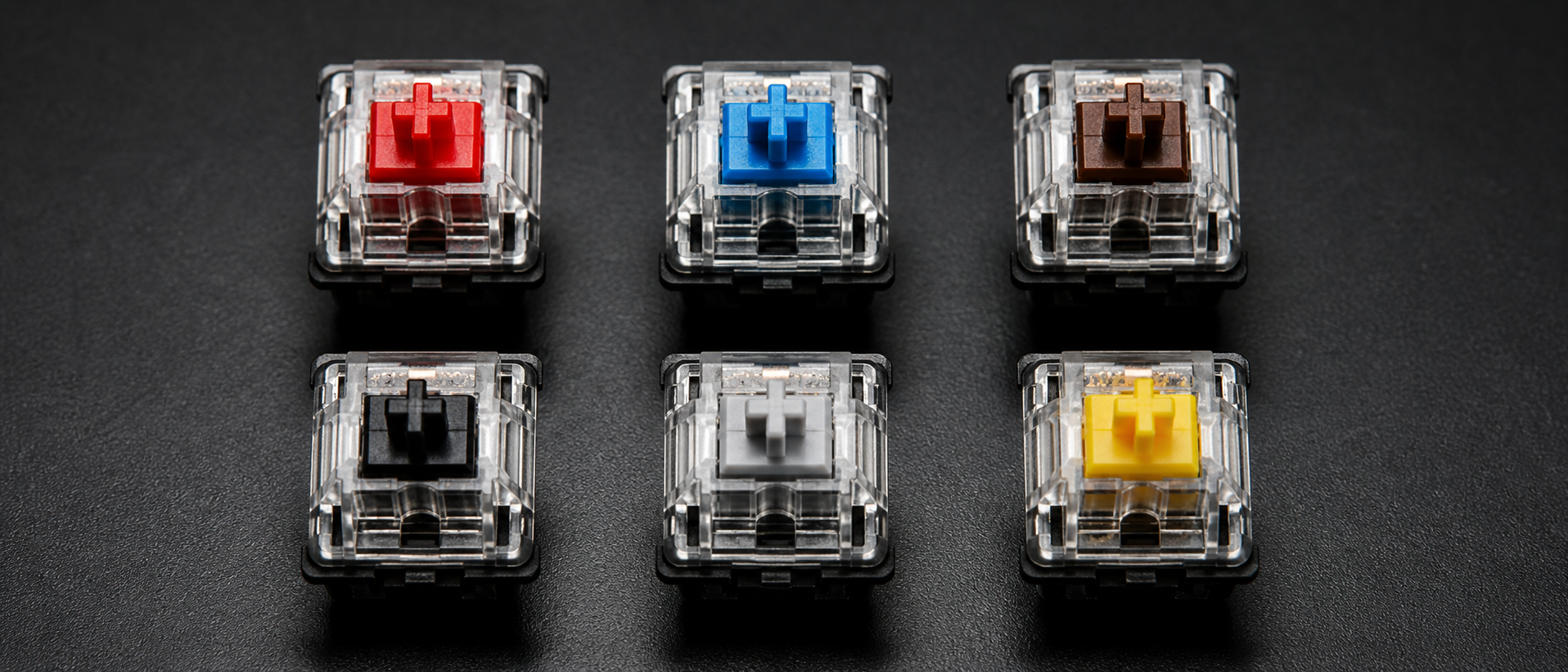 Array of different mechanical keyboard switches in various colors arranged in a grid on dark background